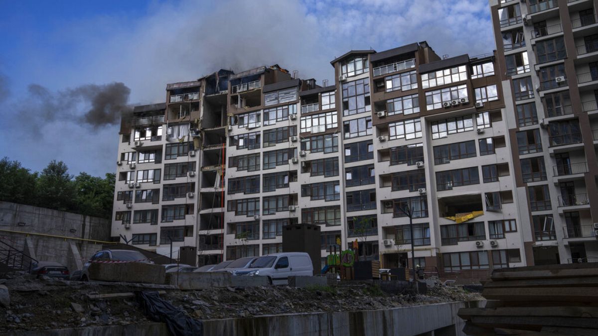 Smoke billows the air from a residential buildings following explosions, in Kyiv, Ukraine, June 26, 2022.