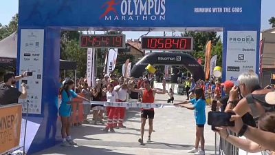 Runners cross the line at the Olympus marathon