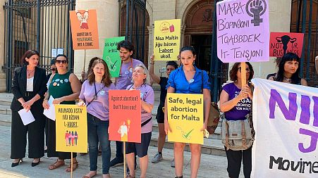 Activists outside the Maltese law courts in Valletta, Malta, Wednesday, June 15, 2022.