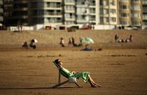 A woman sunbathes during a hot summer day at Zoute beach in Knokke-Heist, north Belgium, Friday, July 31, 2020.