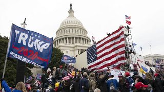 Violent insurrectionists loyal to President Donald Trump stand outside the U.S. Capitol in Washington on Jan. 6, 2021.