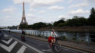 Parisians ride their bikes along the Seine river in Paris, Sunday, May 24, 2020.
