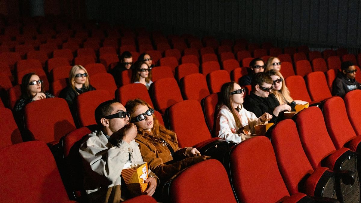 A crowd enjoy a 3D film at the cinema