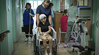 A nurse pushes a wheelchair carrying a woman wounded by the Russian rocket attack at a shopping centre in Kremenchuk in Poltava region, Ukraine, 28 Tuesday, June. 