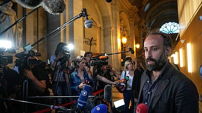 Arthur Dénouveaux, survivor of the Bataclan attack and president of life for Paris association, speaks to the media after the verdict in Paris Wednesday, June 29, 2022.