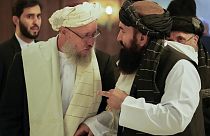 Deputy prime minister Abdul Salam Hanafi (L) speaks with acting Foreign Minister of Afghanistan, Taliban official Amir Khan Muttaqi during an international conference (2021).