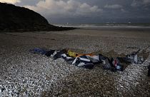 Life jackets and a damaged inflatable small boat on the shore in Wimereux, northern France.