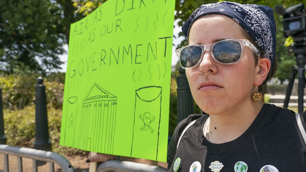 Erin Tinerella, of Chicago, who is in Washington for the summer at an internship, protests against climate change after the Supreme Court's EPA decision, June 30, 2022.