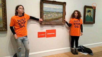 The activists glued themselves to a Van Gogh painting on display in London The activists glued themselves to a Van Gogh painting on display in London