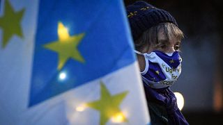 An anti-Brexit pro-Scottish independence activist holds a flag mixing the EU flag and the Scottish Saltire
