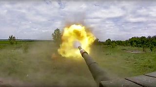 A Russian tank fires at a target in an undisclosed location in Ukraine