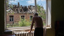 Victor Rosenberg, 81, looks out of a broken window in his home destroyed by the Russian rocket attack in the city centre of Bakhmut, Donetsk region, Ukraine, Friday, July 1, 2
