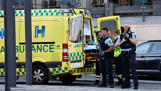 An ambulance and armed police outside the Field's shopping center, in Orestad, Copenhagen, Denmark, Sunday, July 3, 2022, after reports of shots fired