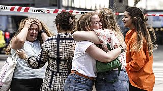 Γυναίκες με δάκρυα στα μάτια αγκαλιάζονται μετά την επίθεση σε εμπορικό κέντρο στην Κοπεγχάγη