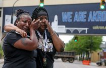 Sandra Dees, left, and Marquita Carter cry in front of the Harold K. Stubbs Justice Center, Sunday, July 3, 2022, in Akron, Ohio, after watching the bodycam footage