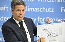 German Minister of Economics and Climate Protection Robert Habeck shows a graph featuring forecasts of gas storage levels