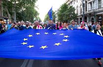 Demonstrators carry a giant EU flag during an anti-government rally near the Georgian Parliament in Tbilisi.