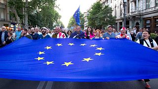 Demonstrators carry a giant EU flag during an anti-government rally near the Georgian Parliament in Tbilisi.