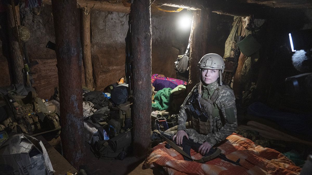 Ukrainian platoon commander Mariia rests in a trench in a position in the Donetsk region on 2 July 2022