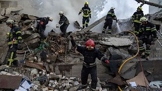 Rescue workers clearing rubble of a destroyed school after an attack in Kharkiv, Ukraine, on Monday, July 4, 2022