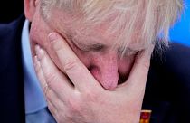 UK Prime Minister Boris Johnson with his hand over his face.