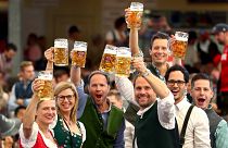In this Saturday, Sept. 21, 2019 file photo, visitors lift glasses of beer during the opening of the 186th 'Oktoberfest' beer festival in Munich, Germany.