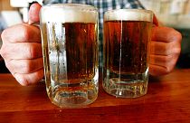 FILE - June 29, 2004 - a bartender serves two mugs of beer at a tavern in Montpelier