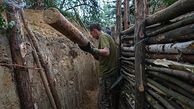 Ukrainian servicemen strengthen trenches on their position near the frontline in Kharkiv region, Ukraine, Tuesday, July, 5, 2022.
