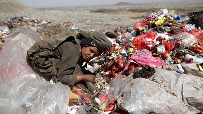 A boy collects recyclable items at a rubbish dump site on the outskirts of Sanaa, Yemen.