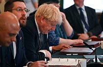 Britain's Prime Minister Boris Johnson, centre, looks at his notes at the start of a cabinet meeting, in Downing Street in London, Tuesday, July 5, 2022.