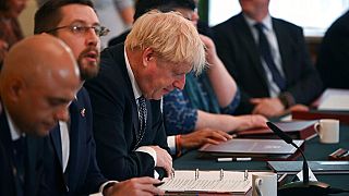 Britain's Prime Minister Boris Johnson, centre, looks at his notes at the start of a cabinet meeting, in Downing Street in London, Tuesday, July 5, 2022. 
