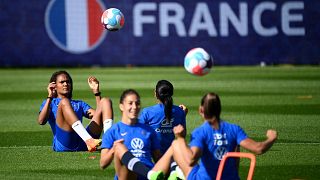 France's defender Wendie Renard (L) plays the ball during a training session at the team's base camp in Ashby-de-la-Zouch in central England, on July 5, 2022