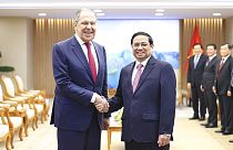 Russian Foreign Minister Sergey Lavrov and Vietnamese Prime Minister Pham Minh Chinh shake hands in Hanoi, Vietnam