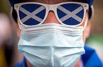 A pro-independence protester wearing a protective face covering to combat the spread of the coronavirus, joins a gathering in George Square, Glasgow