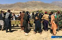 Taliban soldiers gather with weapons and machinery in Panjshir province