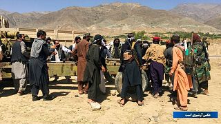 Taliban soldiers gather with weapons and machinery in Panjshir province