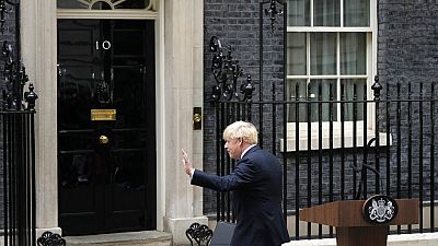 Prime Minister Boris Johnson waves after reading a statement outside 10 Downing Street