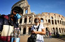 Tourists wear masks on a visit to Rome.