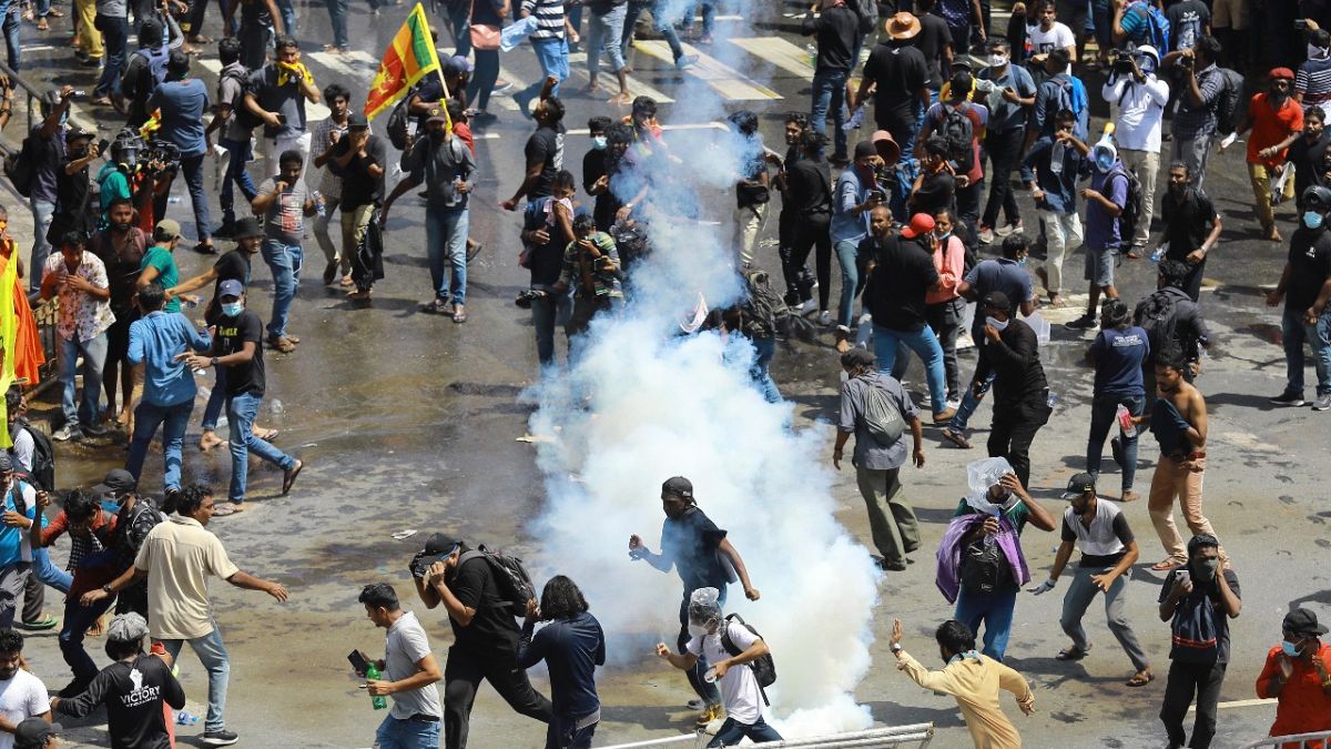 Police use tear gas to disperse the protesters in Colombo, Sri Lanka, Saturday, July 9, 2022. 