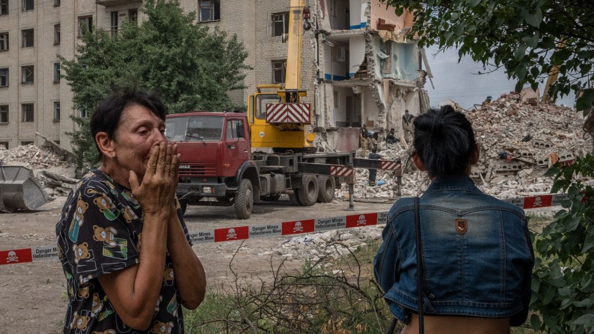 Iryna Shulimova, 59, weeps at the scene in the after math of a Russian rocket that hit a block of flats in Chasiv Yar, Donetsk region, eastern Ukraine, July 10, 2022.