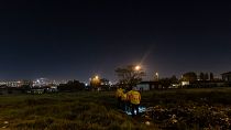People can be seen walking during a night patrol around Pimville, Soweto, May 10, 2022. Daily community patrols increased their presence due to rising crime.