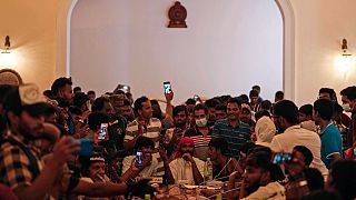 Protesters pretend to hold a cabinet meeting after occupying the president's official residence a day after it was stormed in Colombo, Sri Lanka, July 10, 2022.