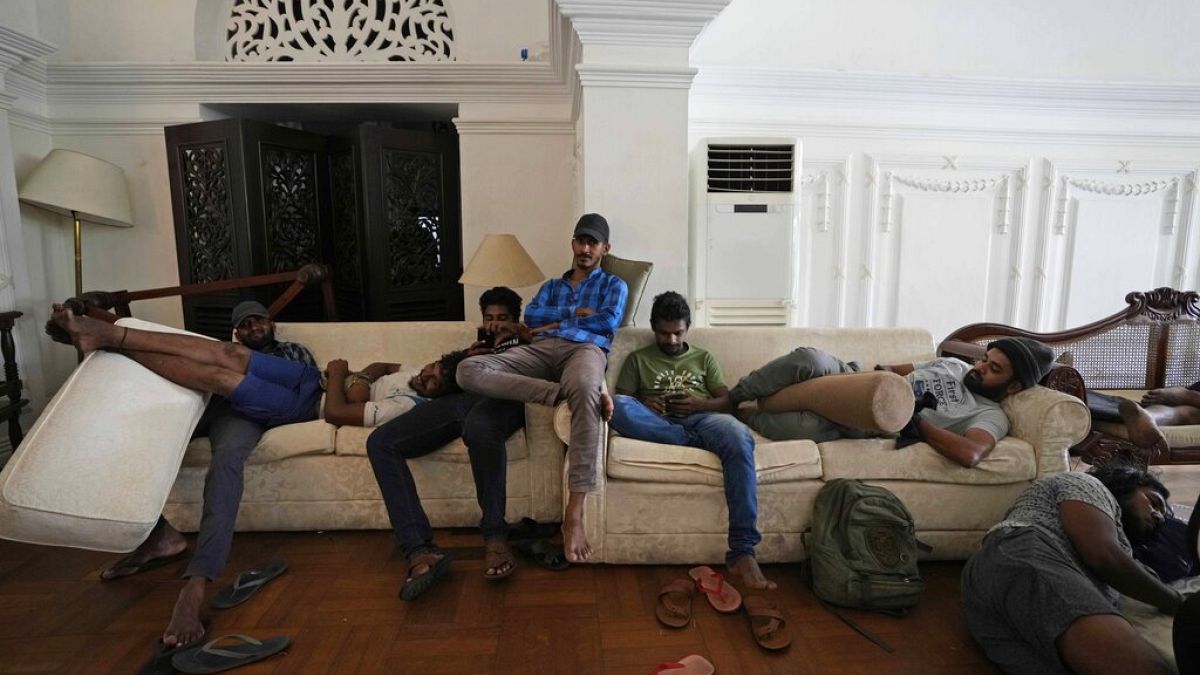 Protesters rest on sofas in the living hall of prime minister's official residence a day after vandalising it in Colombo, Sri Lanka, July 10, 2022. 