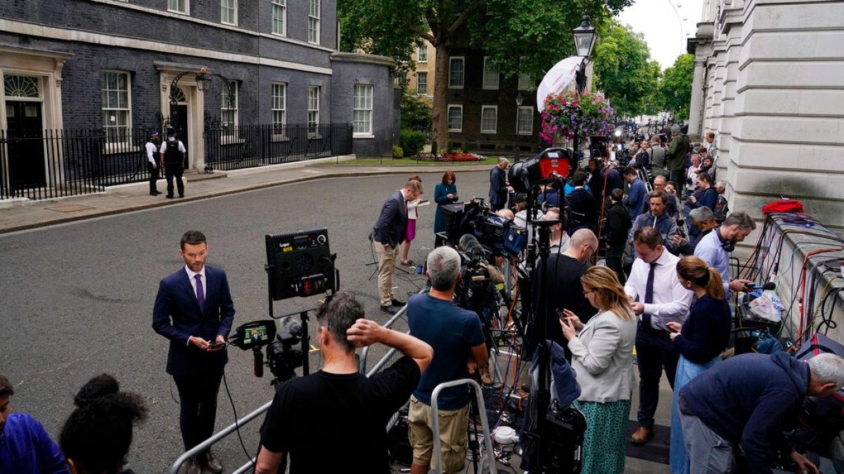 Media gather near 10 Downing Street in London, Thursday, July 7, 2022. 