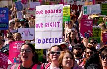 Demonstrators hold placards as they attend a march in support of the Abortion Rights group, in London.