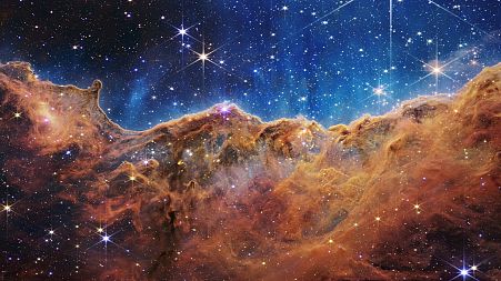 This image released by NASA on Tuesday, July 12, 2022, shows the edge of a nearby, young, star-forming region NGC 3324 in the Carina Nebula.