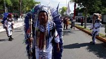 Dancers arrive at the church where mass will be held