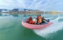 Researchers crossing a fjord in Ny-Ålesund, Svalbard
