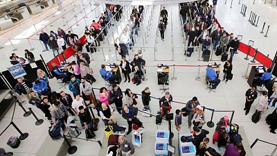 Passengers queue at JFK airport, New York, US.