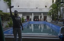 A man takes selfie at the swimmimg pool of the official residence of president Gotabaya Rajapaksa in Colombo, Sri Lanka.